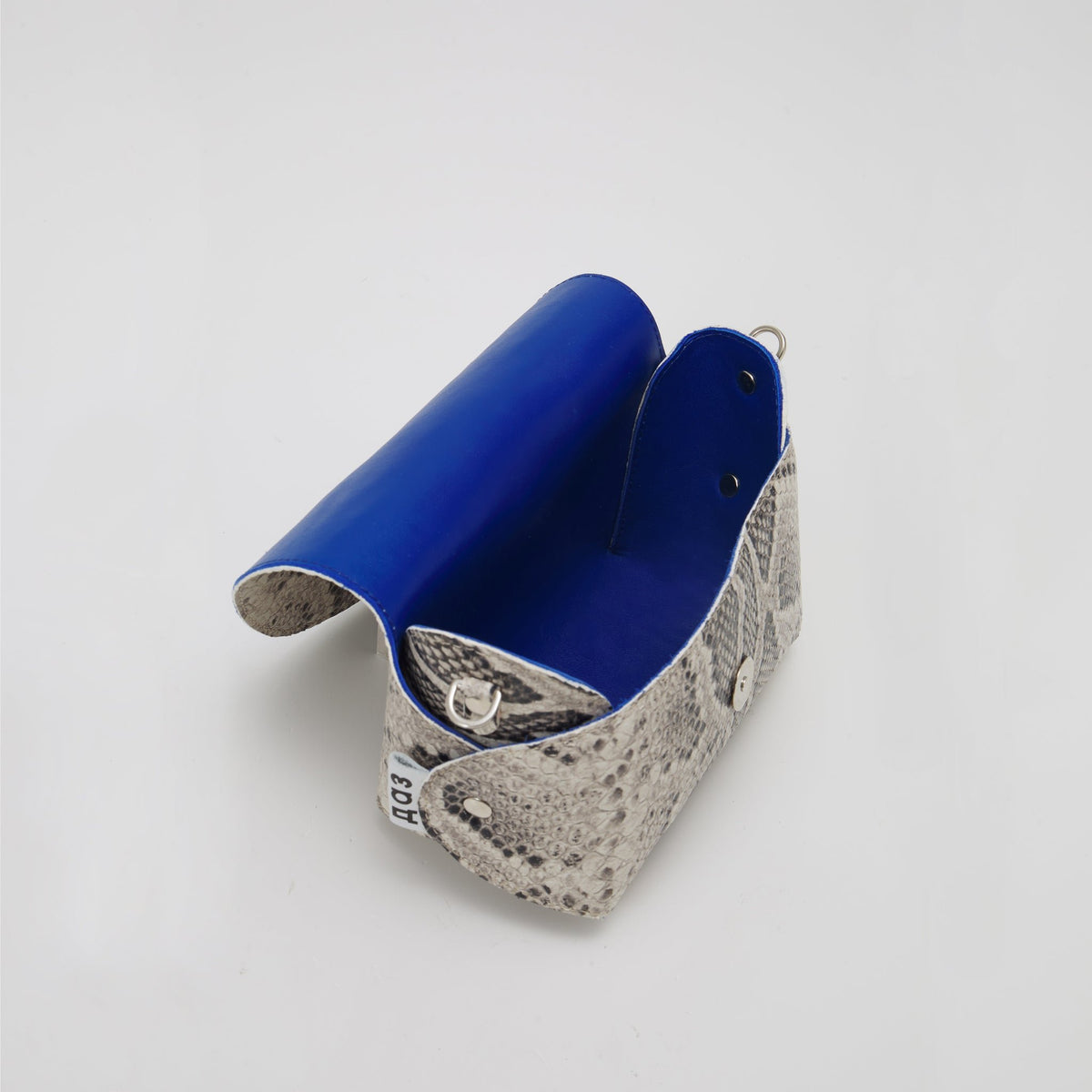 5. Open view of Daz Studio snake print leather bag showing royal blue leather lining