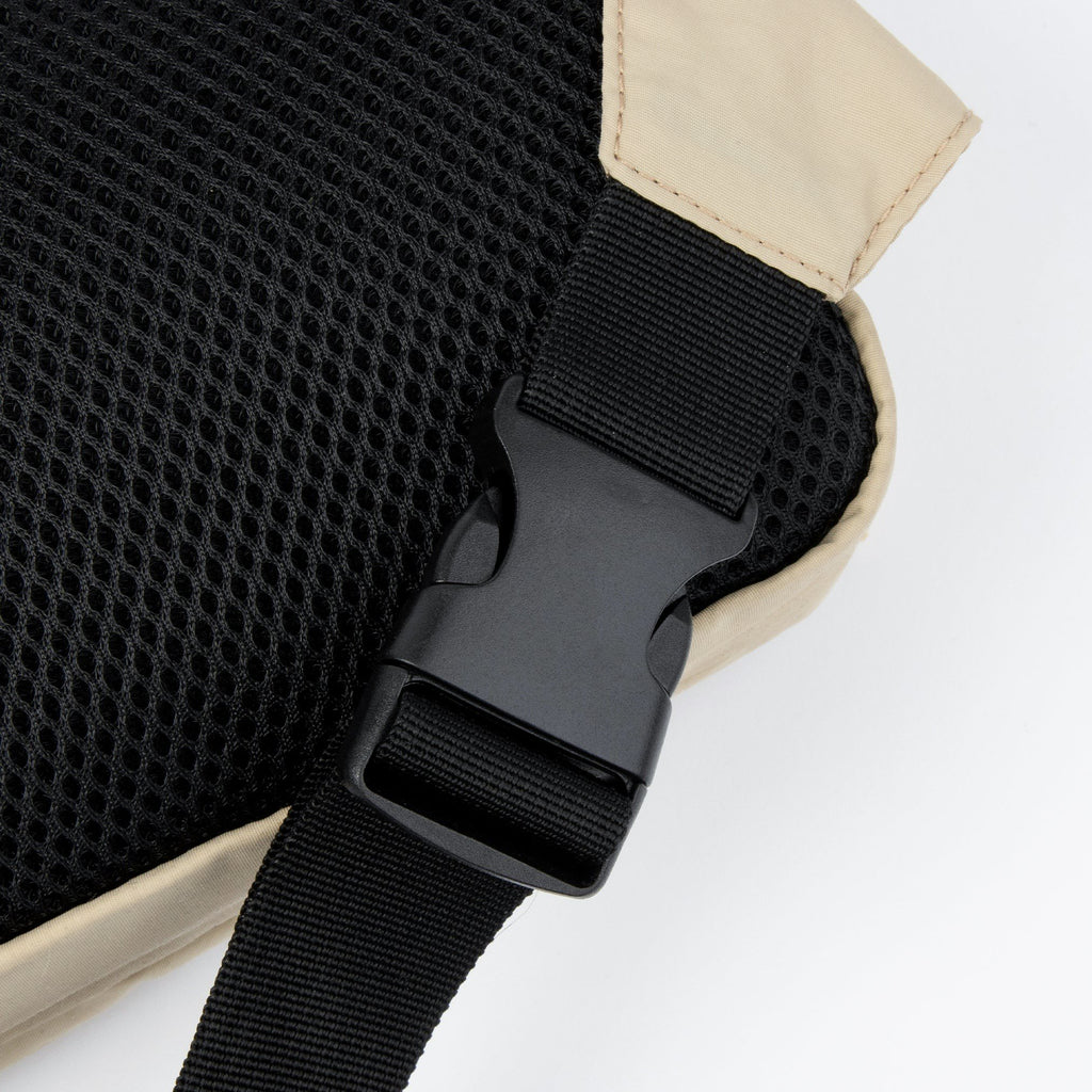 3. Close-up of black buckle and strap on beige Sniff Retro Waist Bag with mesh back