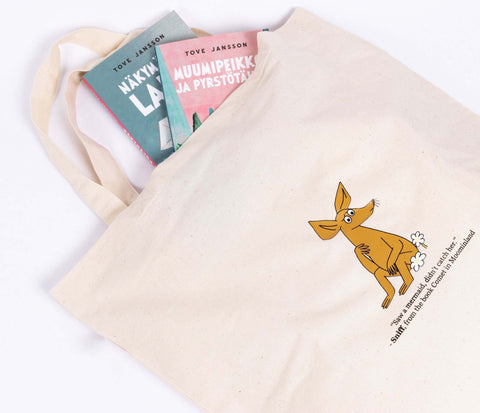 3. Close-up of beige Sniff Tote Bag with books inside, highlighting Sniff character design