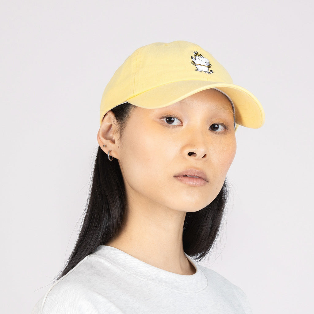 1. Woman wearing Moomin by NordicBuddies Snorkmaiden Dad Cap in yellow, front view
