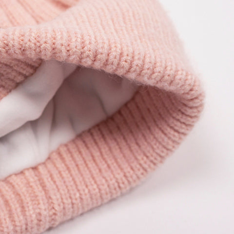 3. Interior view of kids' pink beanie showing soft white fleece lining