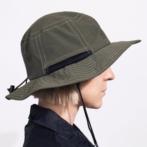 4. Side view of Snufkin Brimmer Hat in green by Moomin, worn by woman, showing brim detail