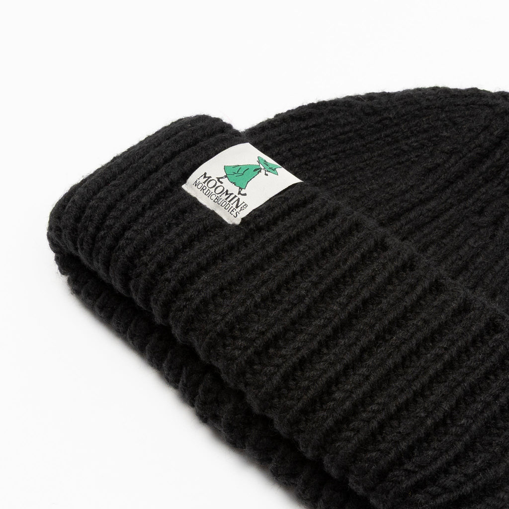 3. Close-up of black chunky beanie showing Moomin by NordicBuddies logo on ribbed fabric
