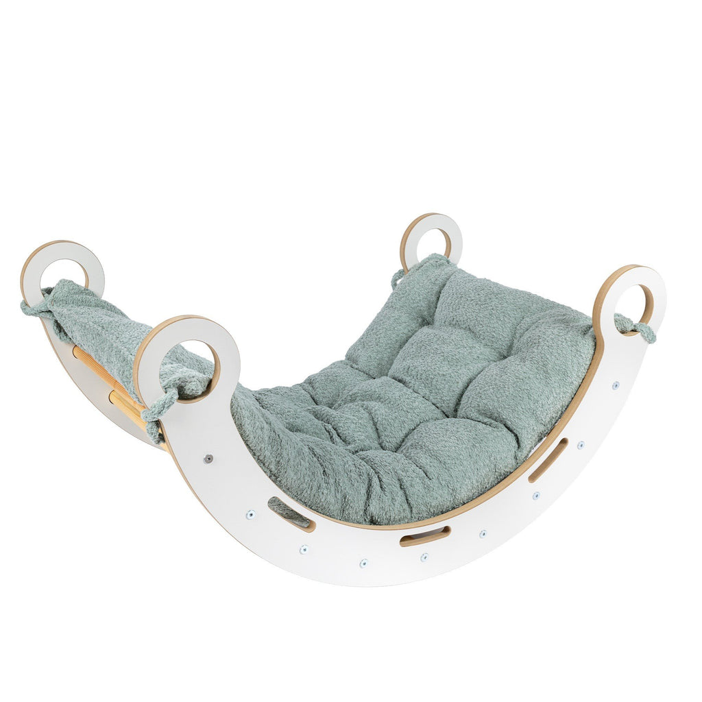 1. Snug Rocker for kids with fresh mint pillow, made of birch plywood, shown in a studio setting