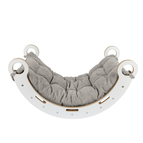 2. Side view of Snug Rocker for kids with tan beige pillow, highlighting smooth birch plywood construction