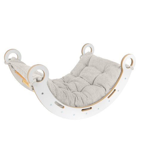 1. Snug Rocker for kids with ecru pillow, featuring smooth birch plywood and rounded edges, shown in a studio setting