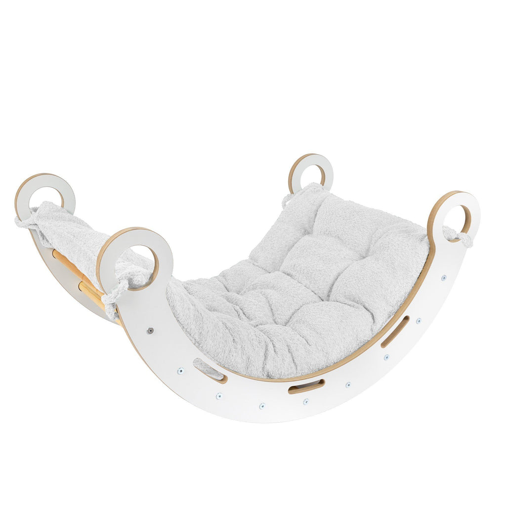 1. Snug Rocker for kids with white pillow, made from birch plywood, shown in a lifestyle setting with rounded edges and comfy handles