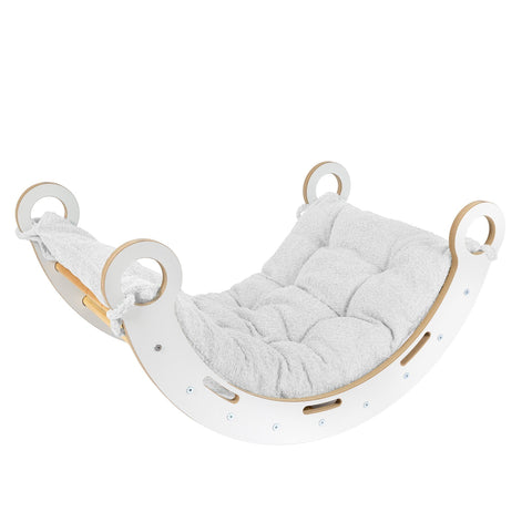 1. Snug Rocker for kids with white pillow, made from birch plywood, shown in a lifestyle setting with rounded edges and comfy handles