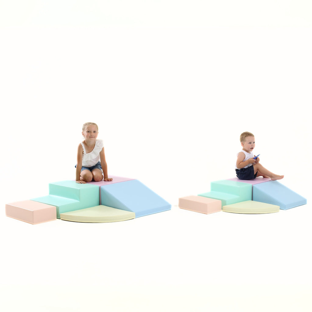 7. Two children playing on separate IGLU pastel foam block sets in a studio