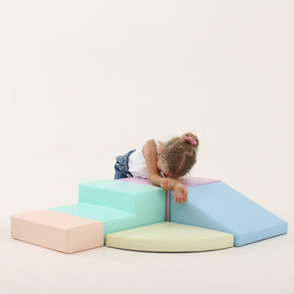 10. Girl resting on IGLU pastel foam block set with steps and ramp in a studio