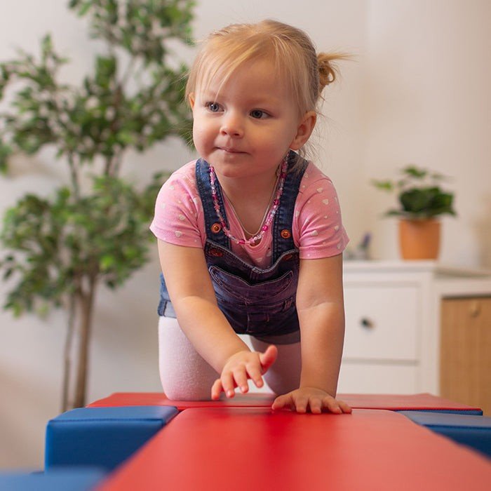 1. Young girl playing on IGLU Soft Play Balance Bridge in a home setting with plants in background