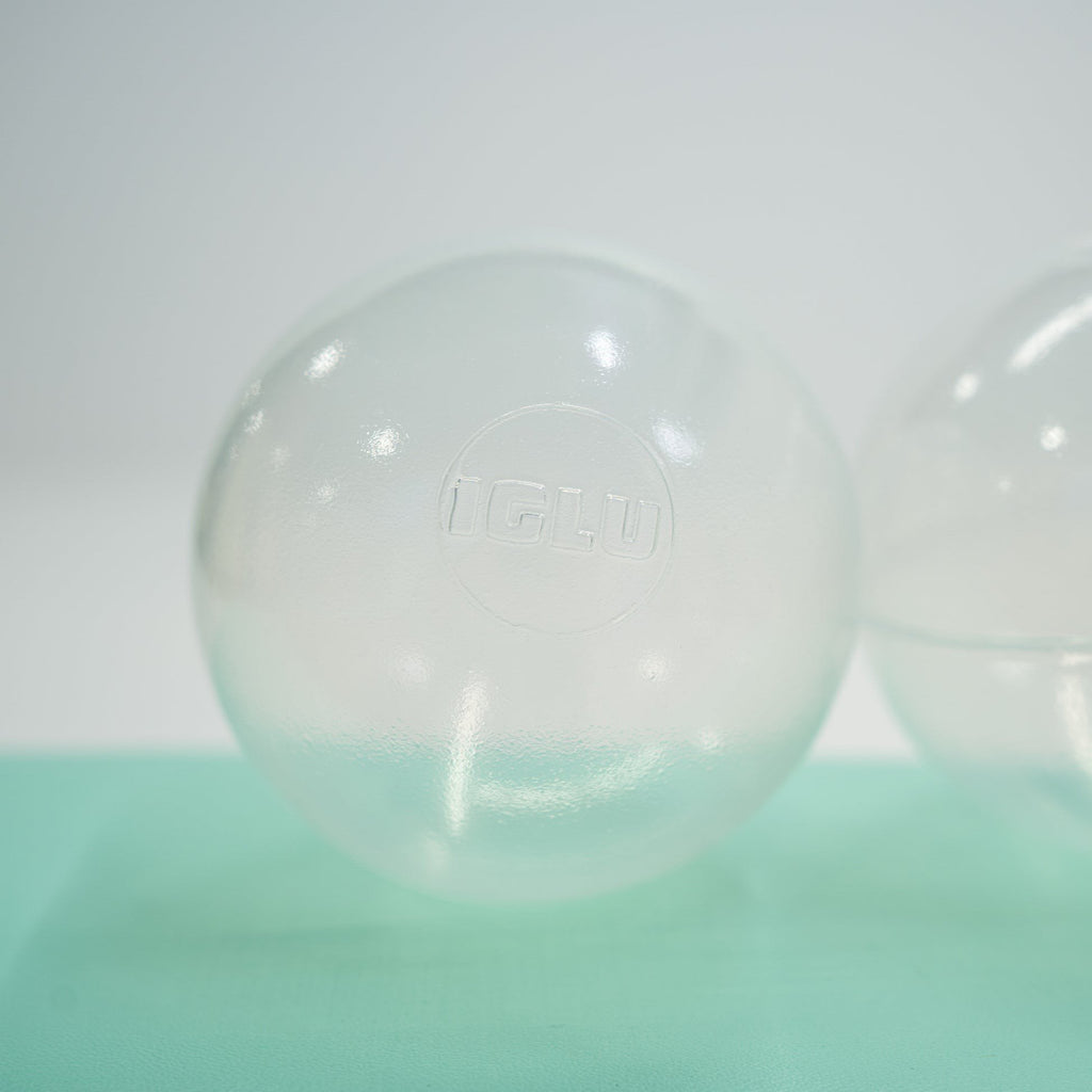 2. Single translucent IGLU soft play ball on light green surface, highlighting logo and smooth finish