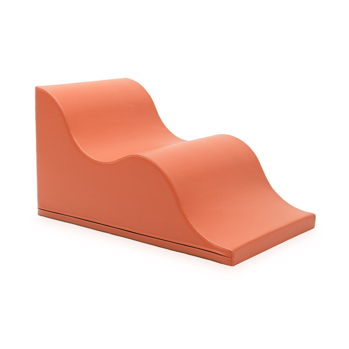 1. Salmon pink wave-shaped soft foam play block by IGLU, shown in a studio setting