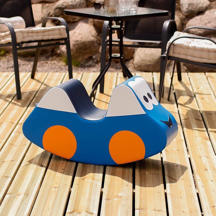 1. IGLU blue soft play ride-on toy car with orange wheels on wooden deck outdoors