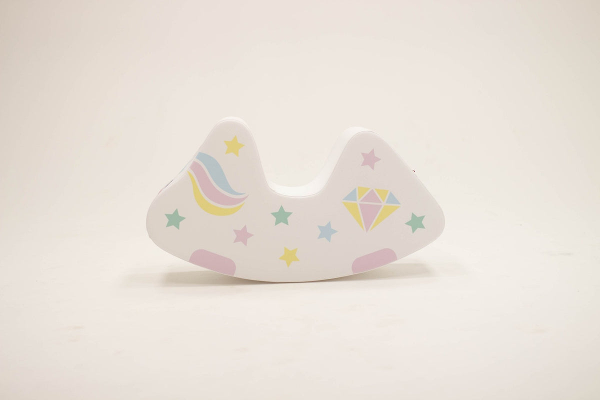 7. Flat lay of IGLU unicorn toy showing side with rainbow and star patterns