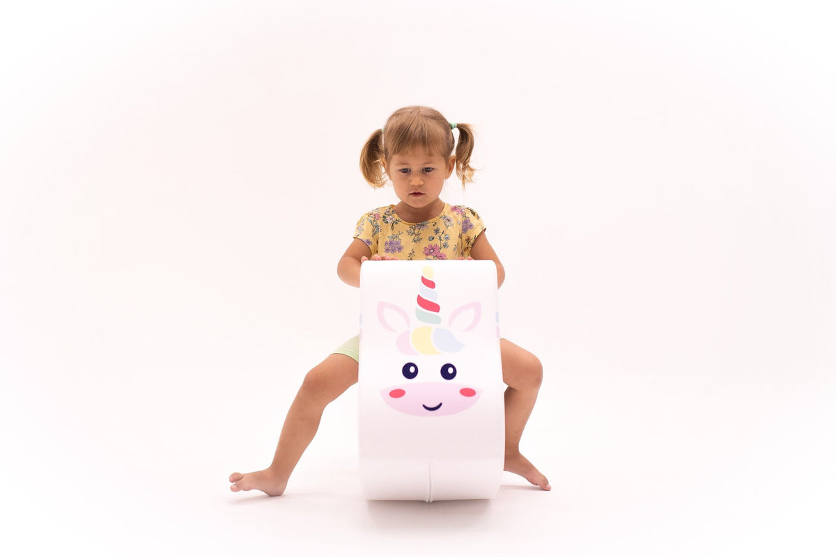 1. Young girl riding IGLU soft play unicorn toy in a studio setting, showcasing balance and coordination