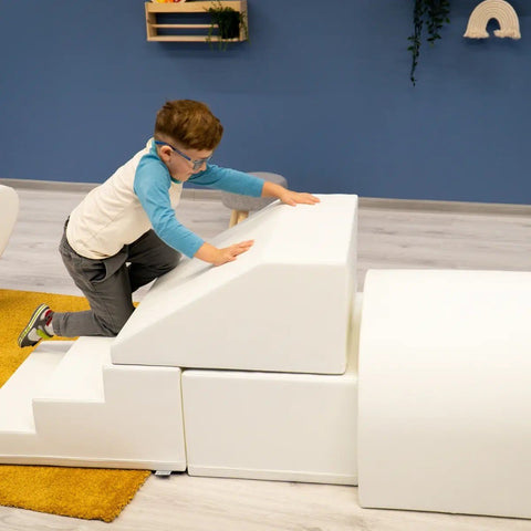 5. Boy climbing white IGLU soft play set with steps and ramp in playroom