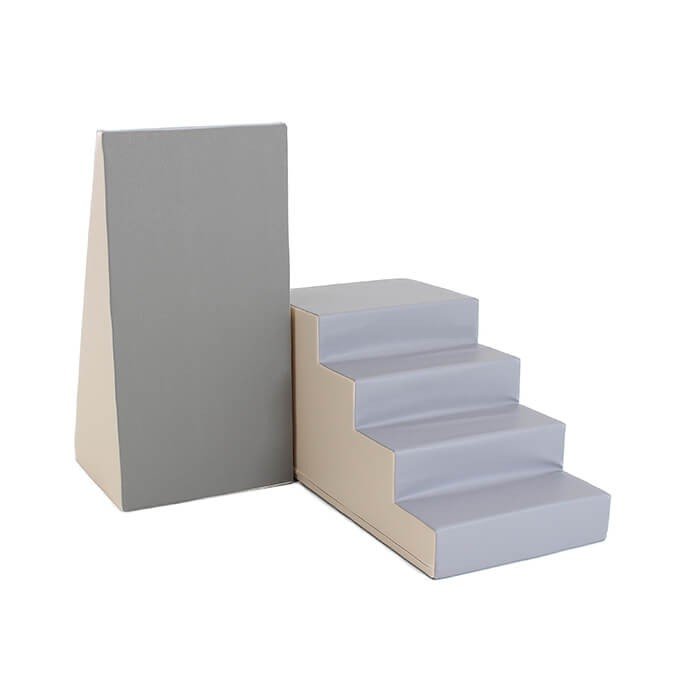 6. Beige and grey soft play step and slide set by IGLU shown upright in a studio setting