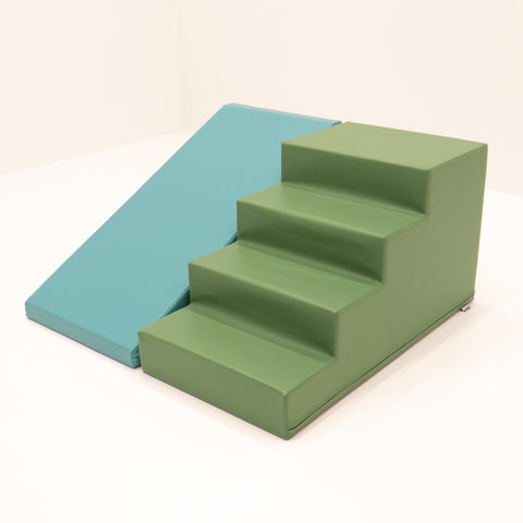3. Studio shot of IGLU soft play step and slide set in pastel turquoise and green, angled view highlighting steps