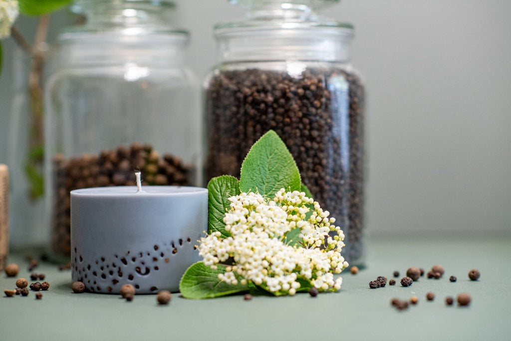 1. Hand-made soy wax candle with patchouli scent by TL Candles, styled with black pepper and myrtle, in a serene setting