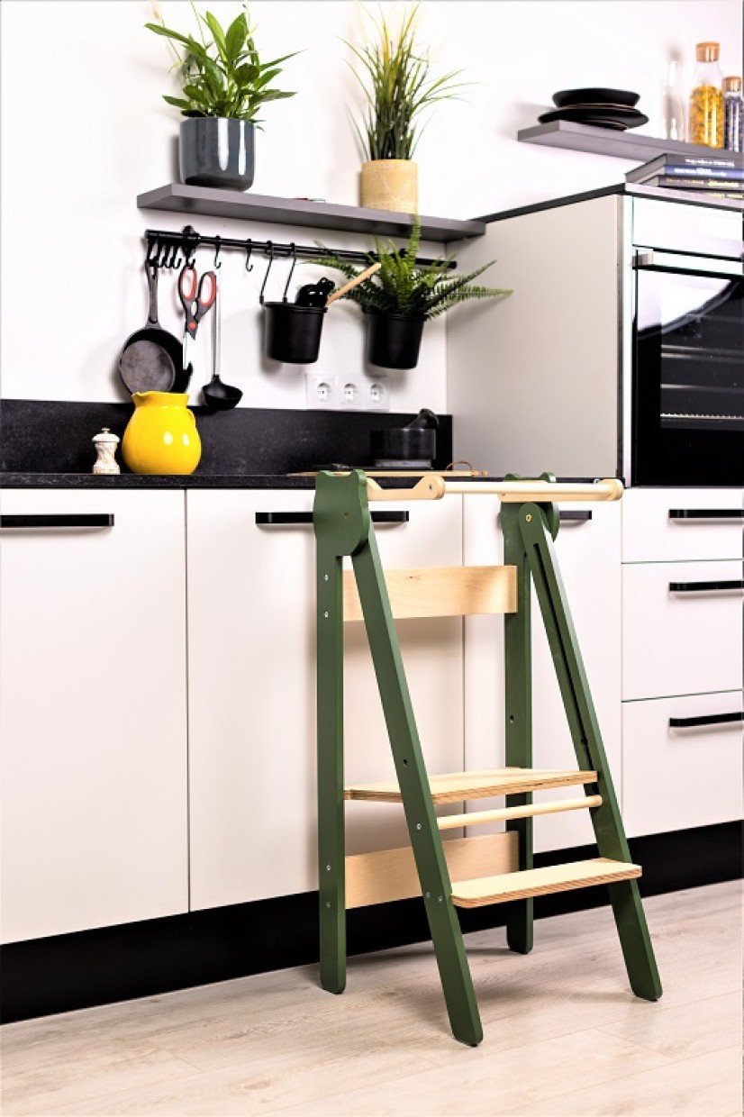 11. Green and natural wood step stool against white kitchen cabinets