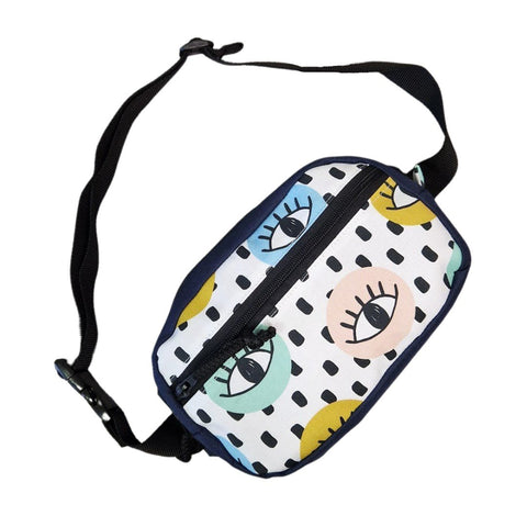 3. Angled view of Drinbags waist bag with eye print and black adjustable strap