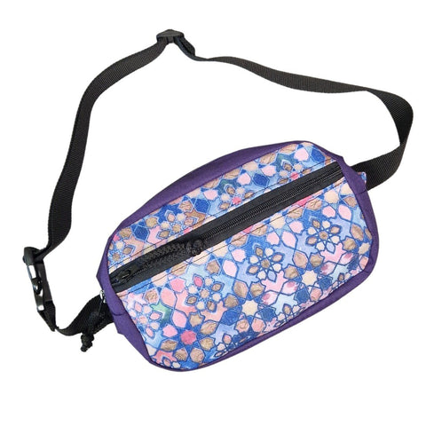 2. Drinbags waist bag in purple with colorful geometric design, black adjustable strap, shown at an angle