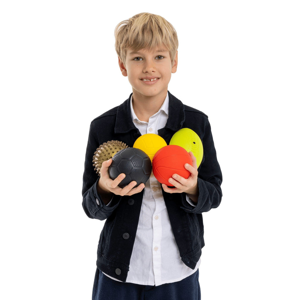 1. Boy holding five colorful Gerardo's Toys sports balls against white background