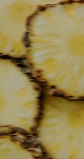9. Close-up of sliced pineapple showing yellow flesh and brown rind