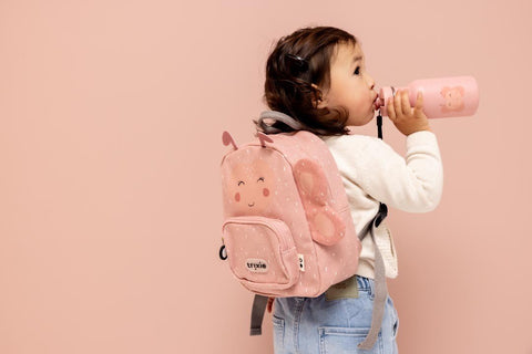 1. Child drinking from pink stainless steel bottle with butterfly design, wearing matching backpack
