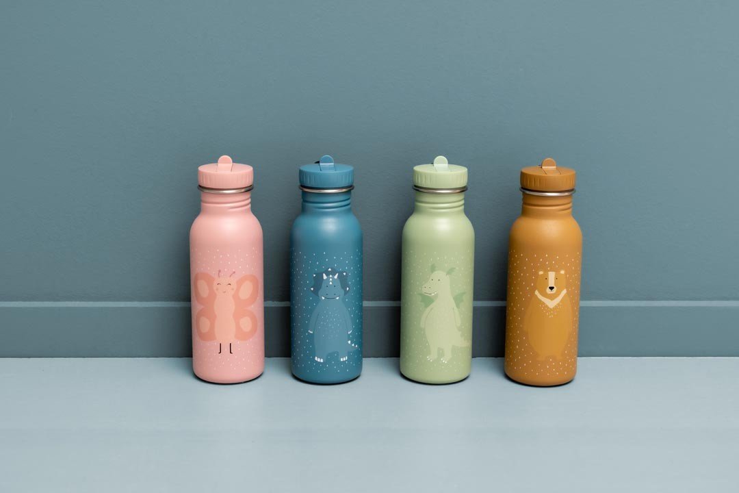 3. Four Trixie Baby stainless steel bottles in pink, blue, green, and brown with animal illustrations, against blue background