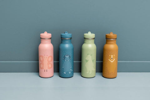 3. Four Trixie Baby stainless steel bottles in pink, blue, green, and brown with animal illustrations, against blue background