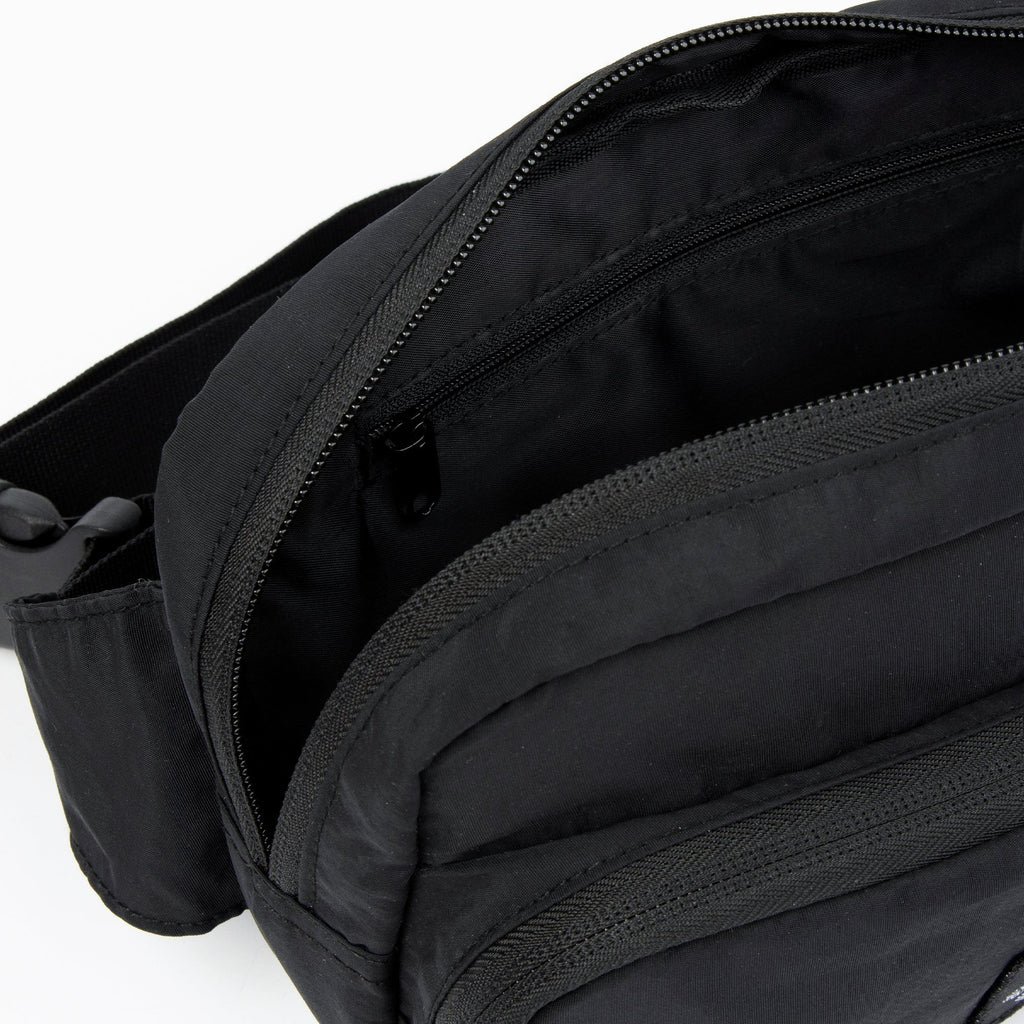 4. Interior view of black Stinky Retro Waist Bag by Moomin showing zippered pocket