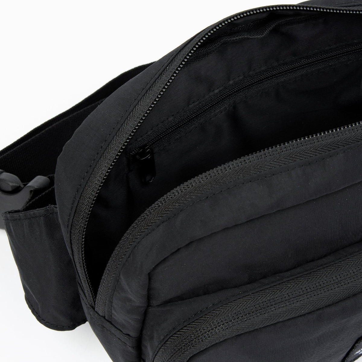 4. Interior view of black Stinky Retro Waist Bag by Moomin showing zippered pocket