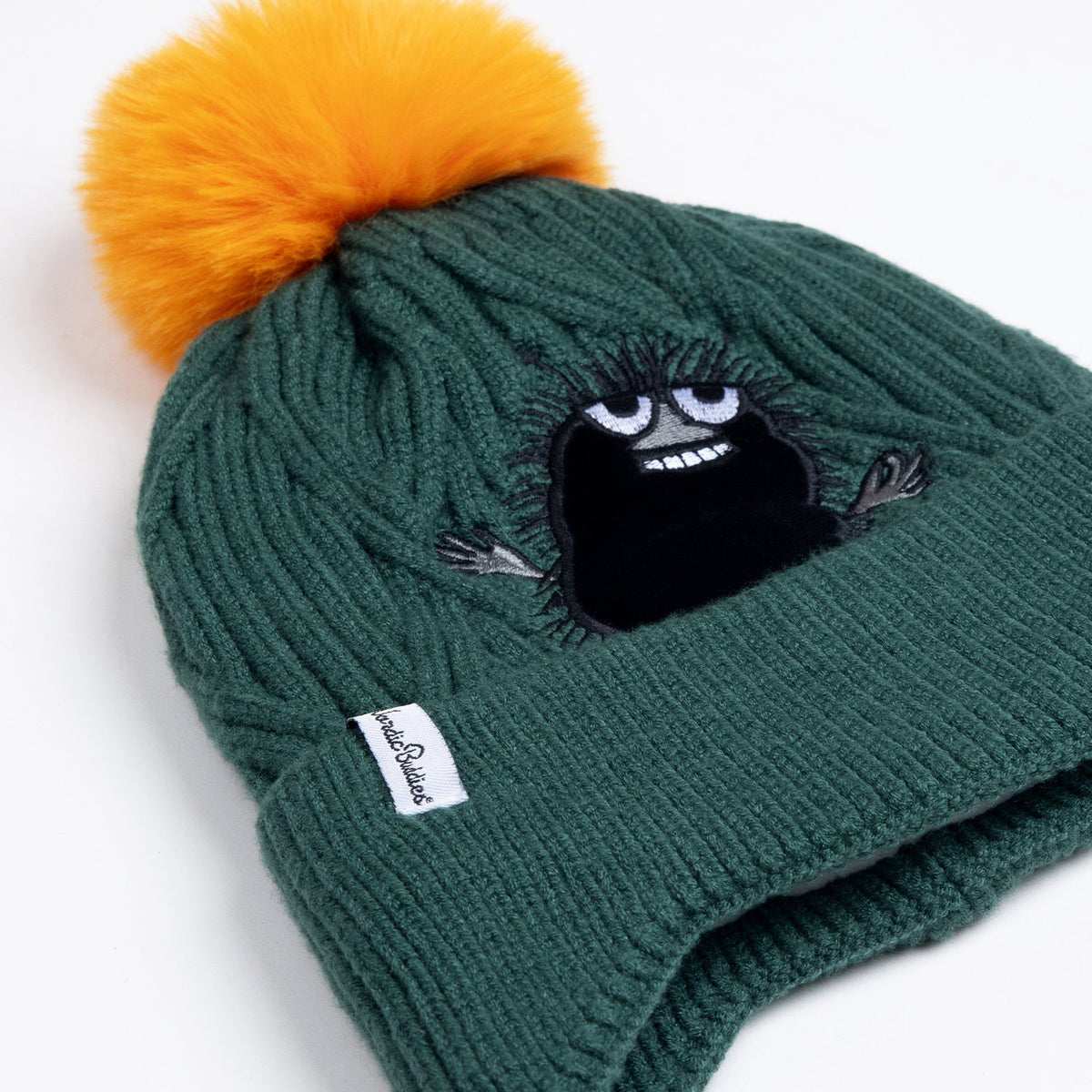 2. Close-up of kids' green beanie with orange pom-pom and Stinky character, highlighting NordicBuddies logo tag