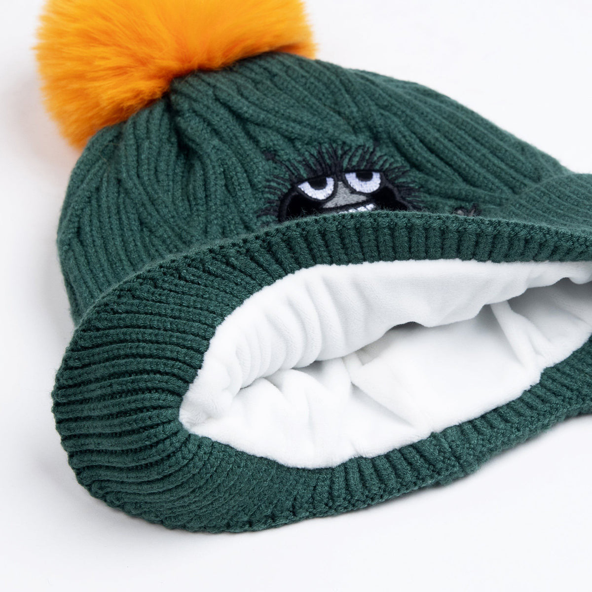 3. Interior view of kids' green beanie showing soft white fleece lining and Stinky character detail