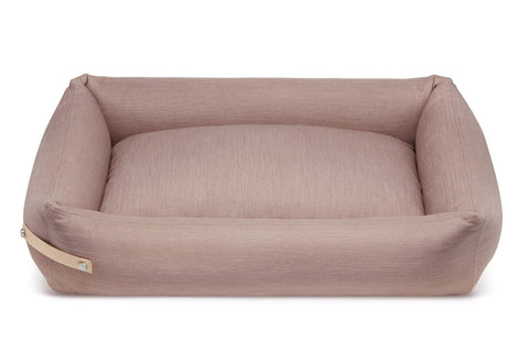 2. Pink Labbvenn Stokke dog bed with leather handle shown in studio lighting