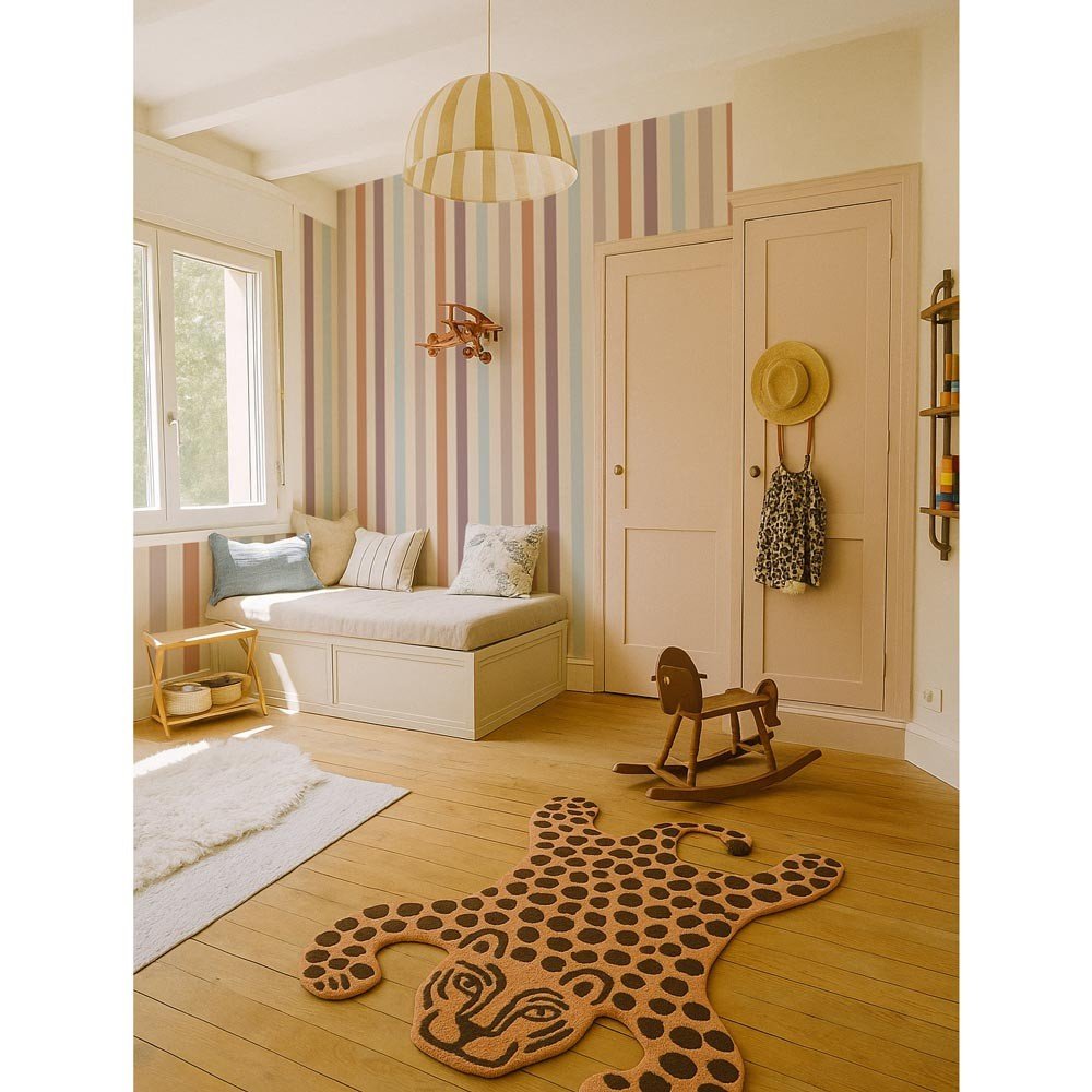 1. Children's room with warm striped wallpaper in beige, blue, and orange tones, featuring a cozy seating area, wooden rocking horse, and decorative rug