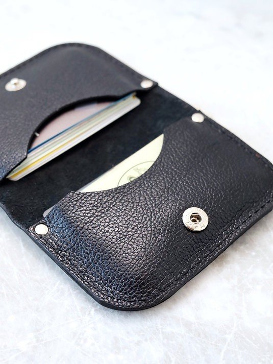 3. Close-up of black textured leather wallet by TOKS VISOKS with visible card slots
