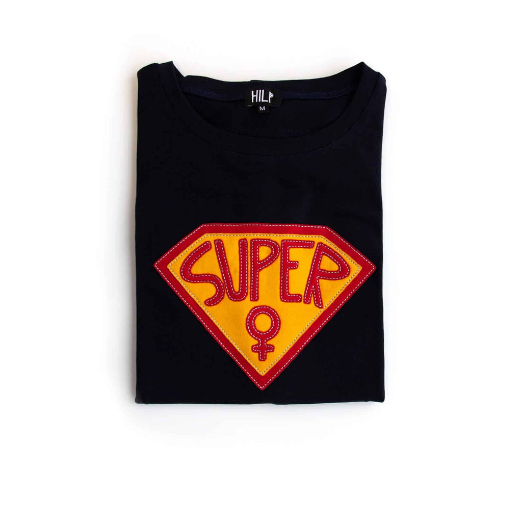 3. Flat lay of black Superwoman T-Shirt by HILP with red and yellow emblem, folded