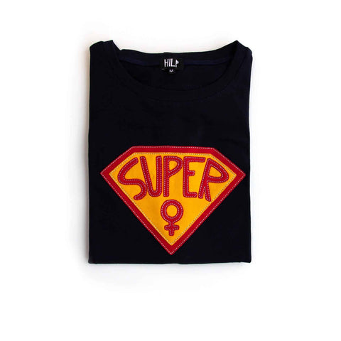 3. Flat lay of black Superwoman T-Shirt by HILP with red and yellow emblem, folded