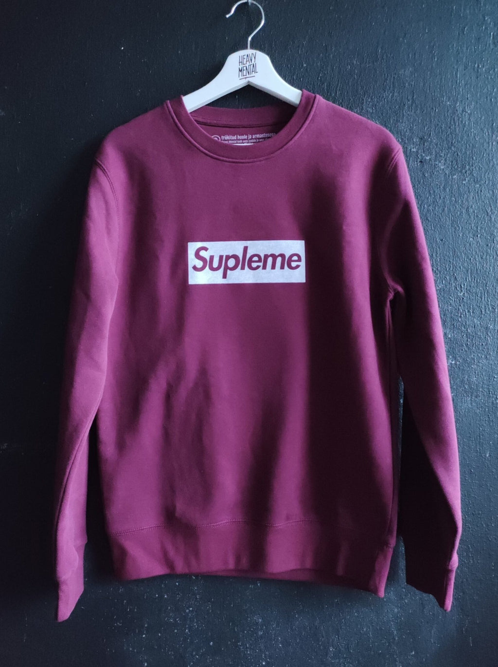 1. Heavy Mental Supleme Sweatshirt in bordeaux, classic pullover design, shown on hanger in studio setting