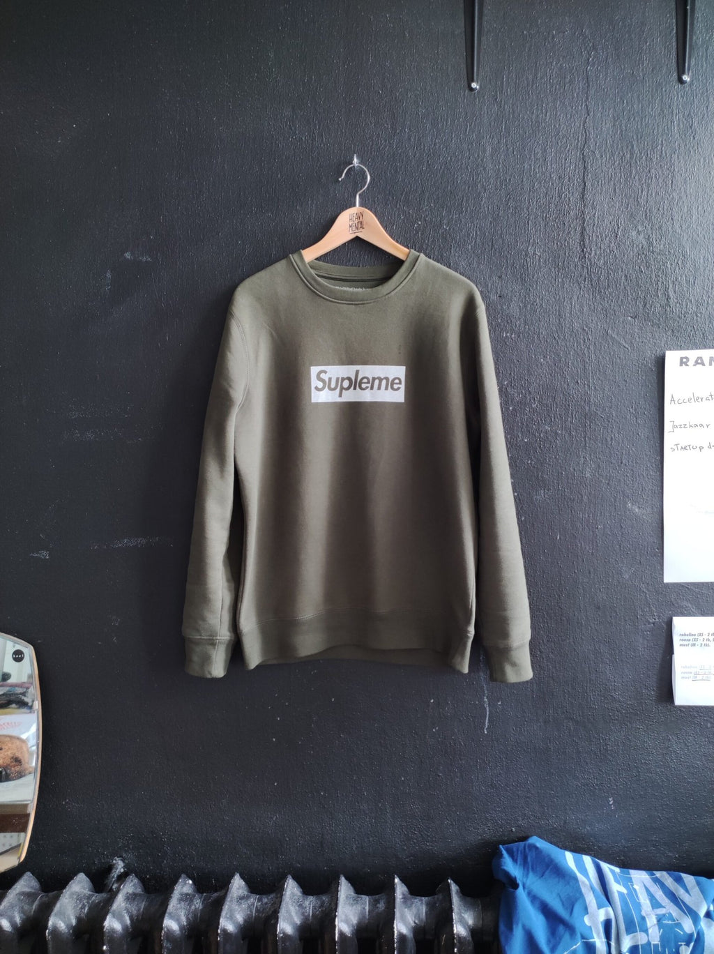 3. Khaki Supleme sweatshirt by Heavy Mental displayed in studio setting, emphasizing handprinted logo