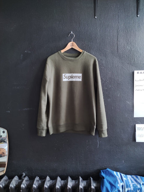 3. Khaki Supleme sweatshirt by Heavy Mental displayed in studio setting, emphasizing handprinted logo