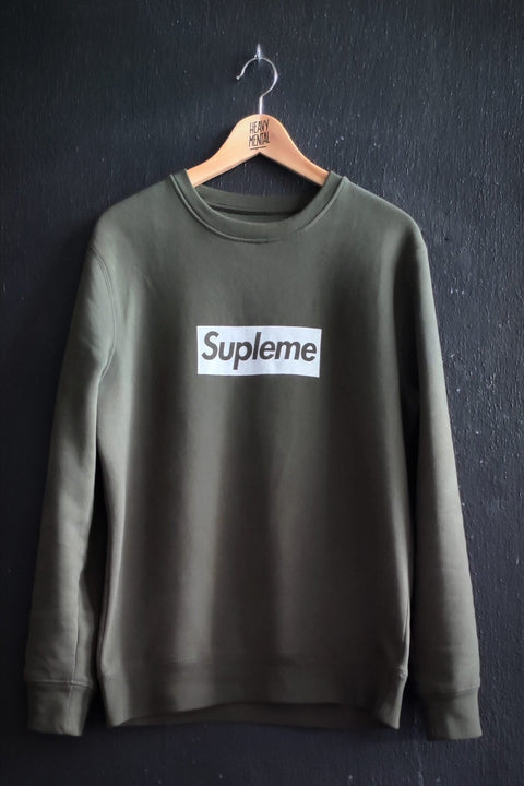 2. Studio shot of khaki Supleme sweatshirt by Heavy Mental on hanger, highlighting design and color