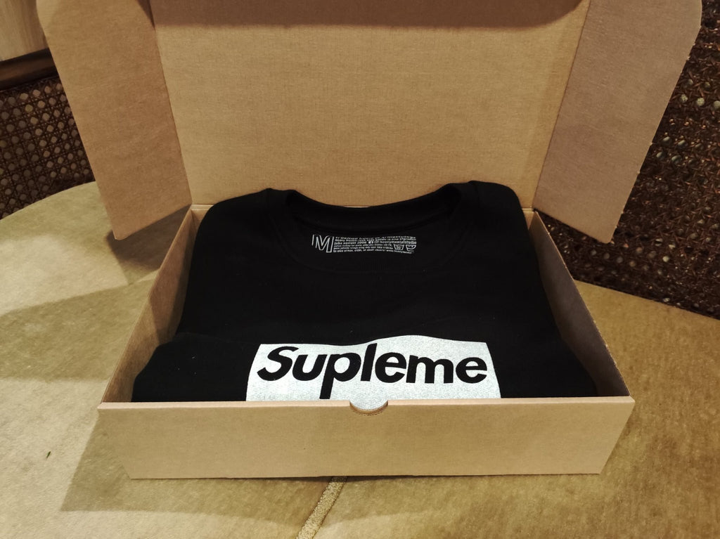2. Supleme Sweatshirt by Heavy Mental in black, shown in packaging with visible logo