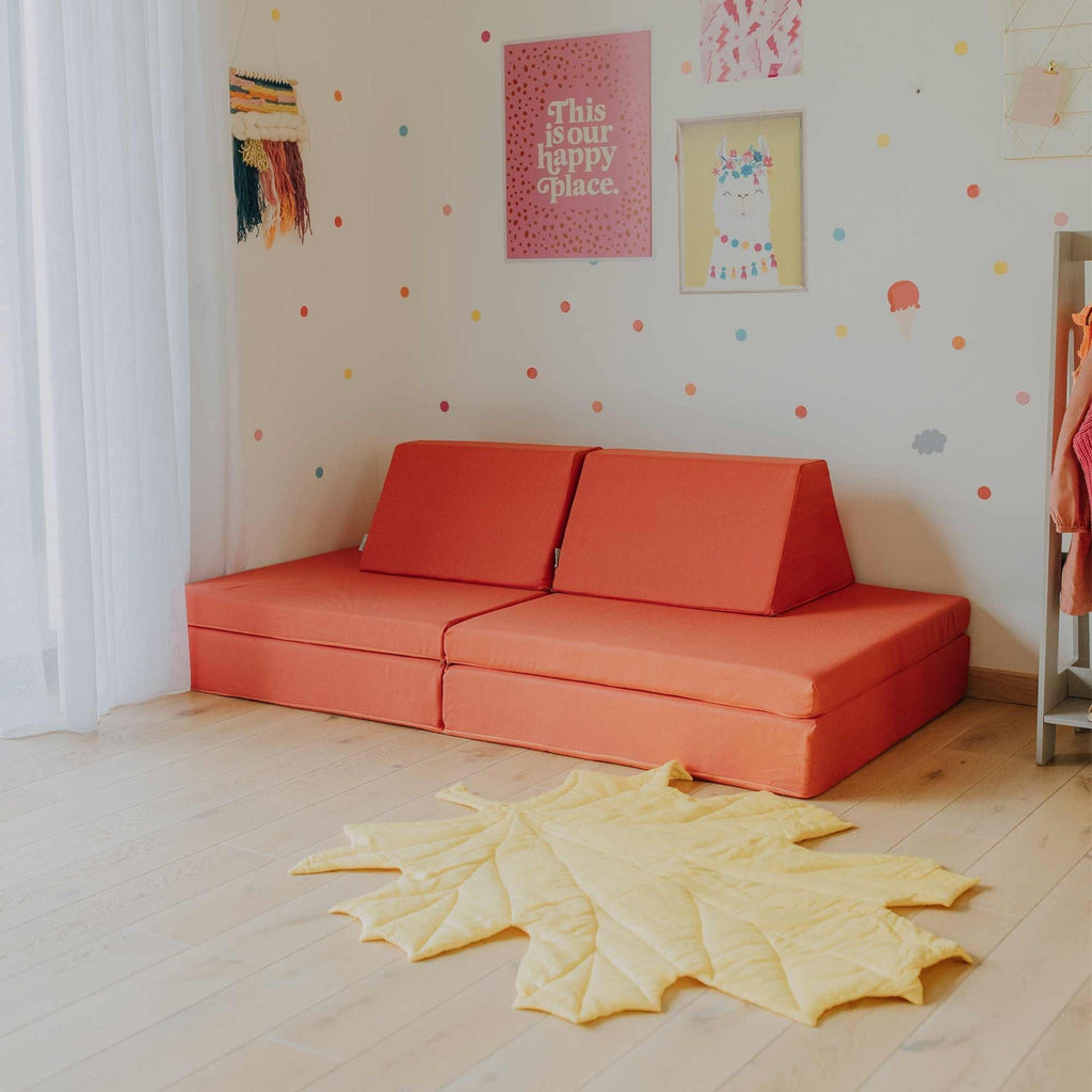 9. Coral activity play mattress set arranged as a sofa in a decorated room with a yellow rug