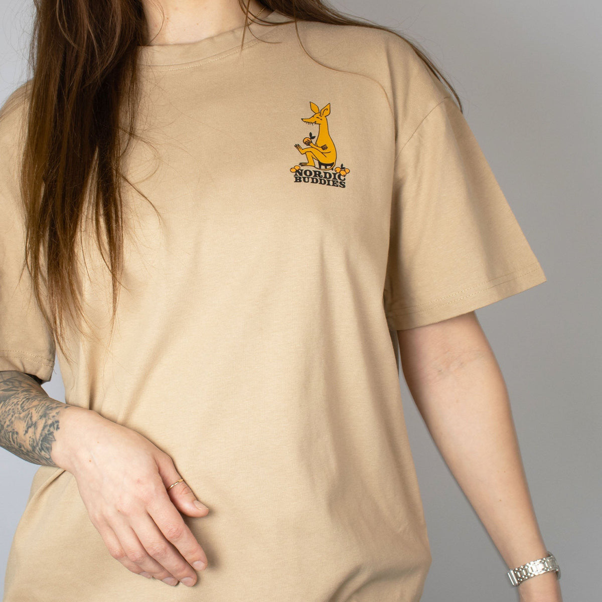 3. Unisex beige Moomin by NordicBuddies t-shirt with Sniff design, worn by female model, showing front logo in lifestyle setting