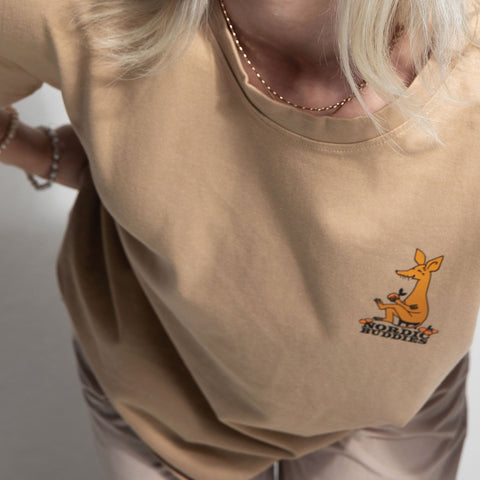 4. Unisex beige Moomin by NordicBuddies t-shirt with Sniff design, worn by female model, showing front logo in lifestyle setting