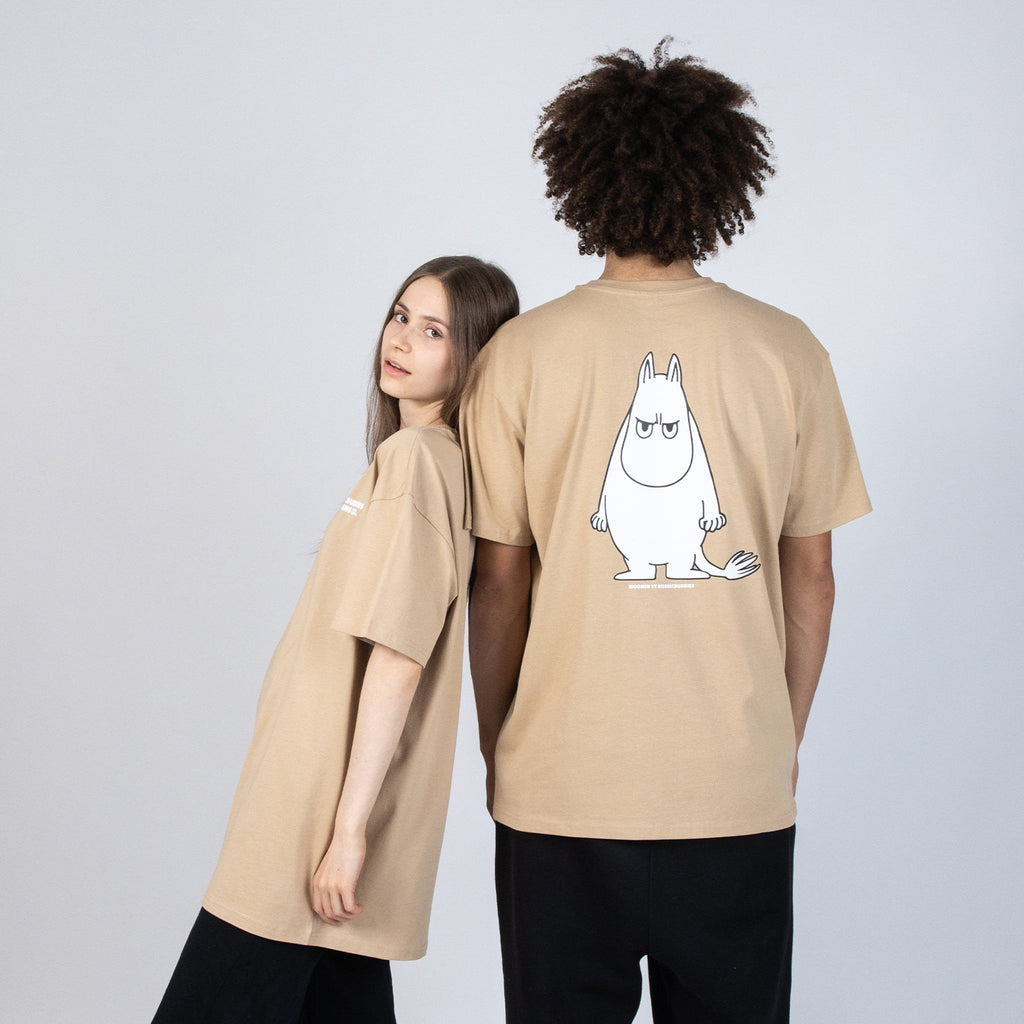 1. Unisex beige Moomin t-shirt worn by male and female models, showcasing oversized fit and back design in studio